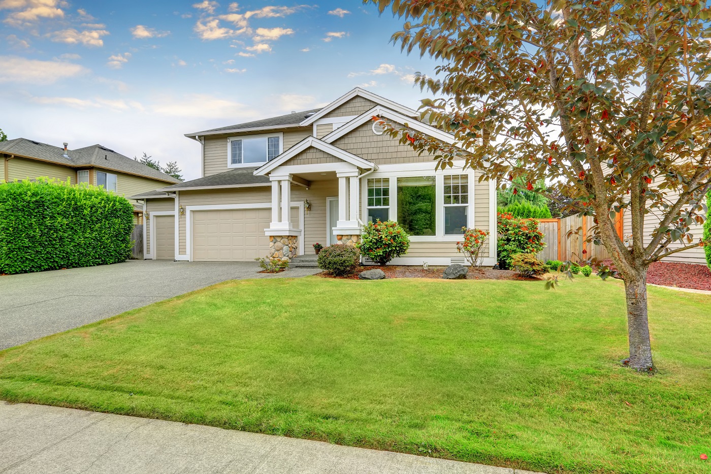 Neat beige home with two garage spaces.