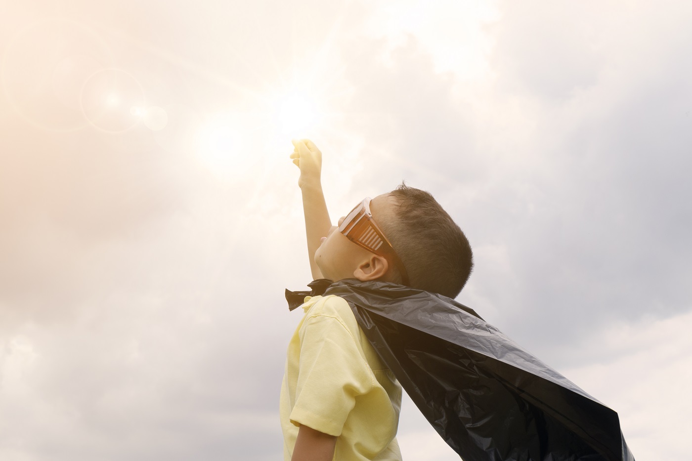 happy kid playing superhero